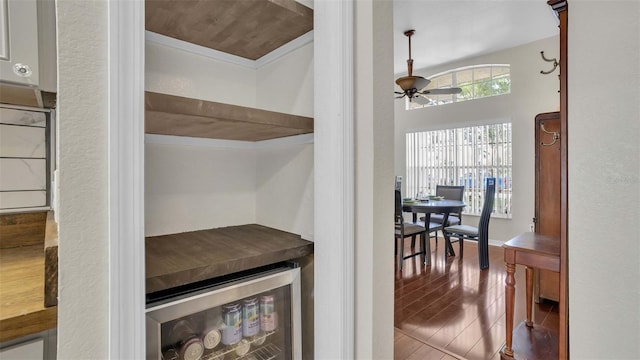 interior space with wine cooler, tile patterned flooring, and ceiling fan