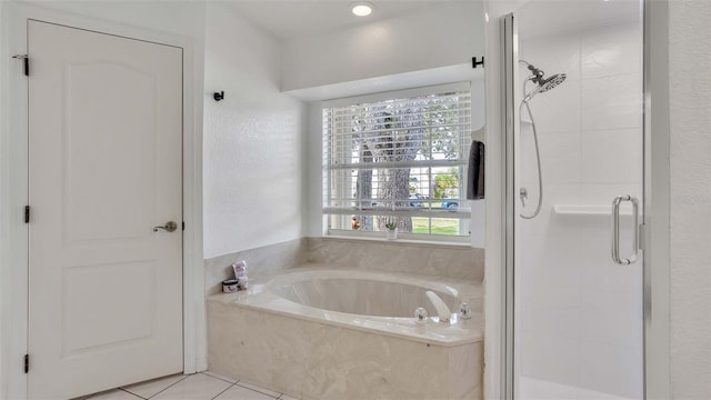 bathroom with tile patterned floors and shower with separate bathtub