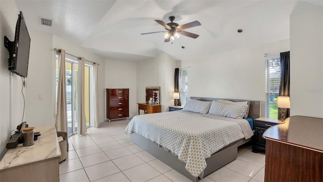 bedroom with lofted ceiling, light tile patterned floors, and ceiling fan