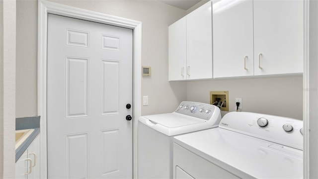 washroom with washer and clothes dryer and cabinets