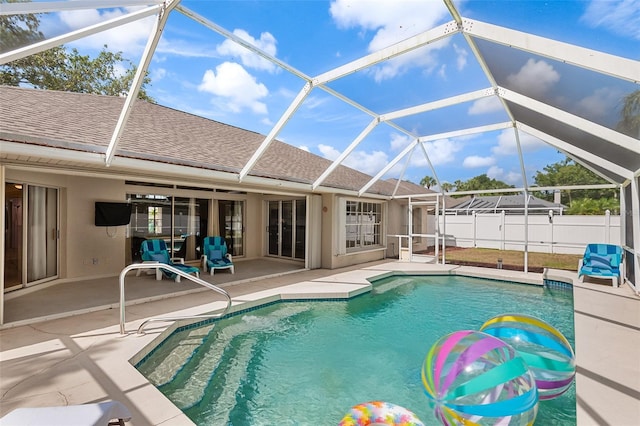 view of pool with a patio, fence private yard, a fenced in pool, and glass enclosure