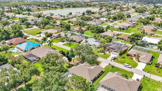 drone / aerial view featuring a water view and a residential view