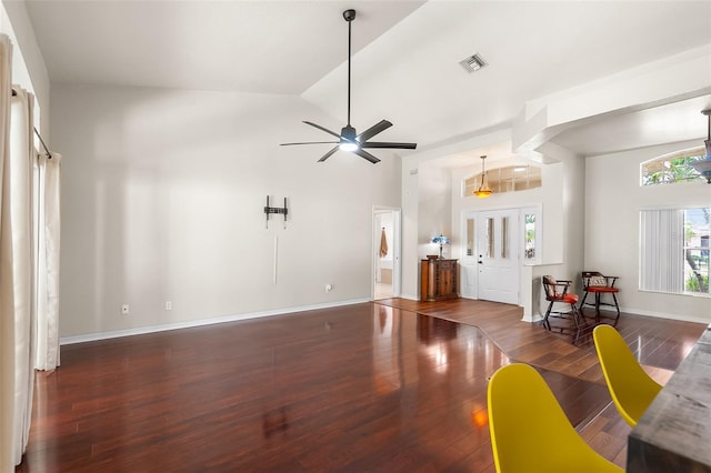 living area featuring wood finished floors, high vaulted ceiling, visible vents, baseboards, and ceiling fan