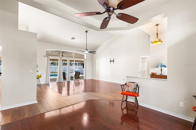 interior space featuring visible vents, baseboards, ceiling fan, and hardwood / wood-style flooring