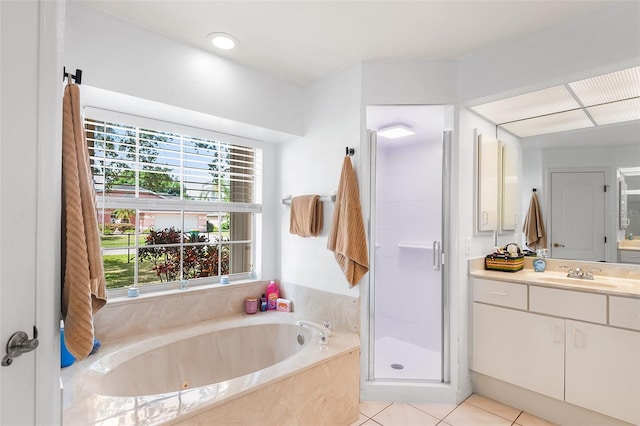 bathroom with vanity, a whirlpool tub, a shower stall, and tile patterned flooring