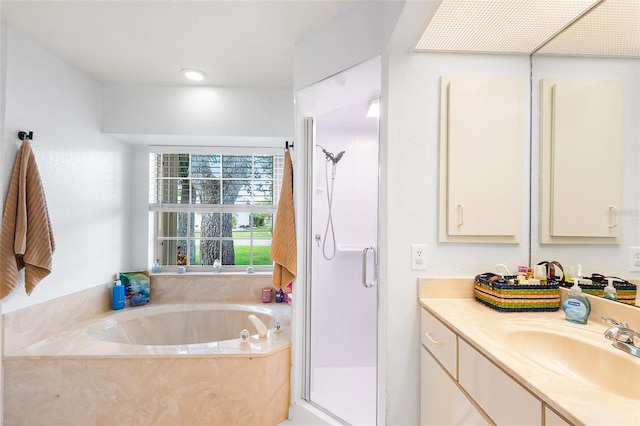 bathroom featuring a stall shower, vanity, and a bath