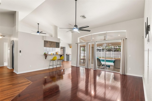 23338 Duchess Ave, Port Charlotte, FL 33954 - unfurnished living room featuring ceiling fan, wood finished floors, and vaulted ceiling