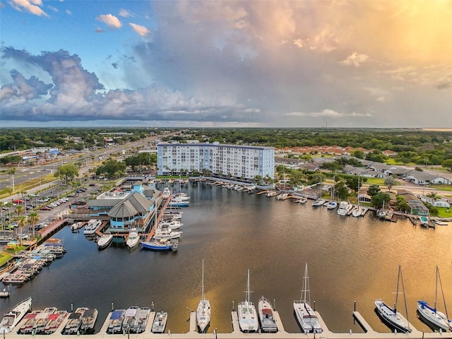 aerial view at dusk featuring a water view