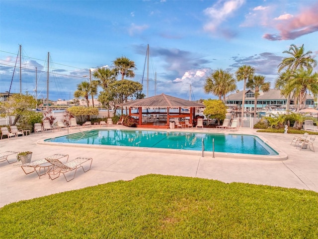 view of pool with a patio area, a lawn, and a gazebo