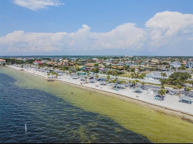 drone / aerial view featuring a beach view and a water view