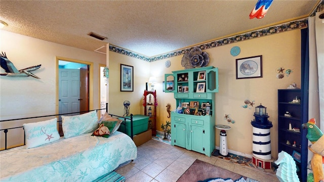 tiled bedroom with a textured ceiling