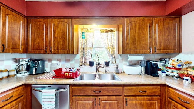 kitchen with stainless steel dishwasher, backsplash, and sink