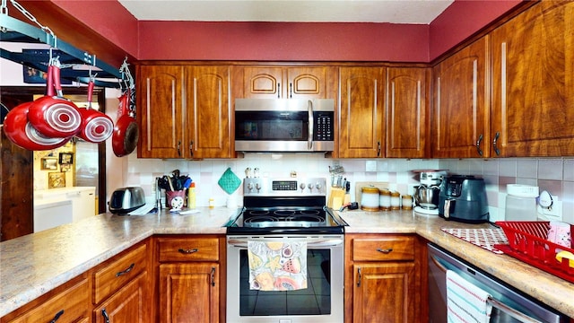 kitchen featuring appliances with stainless steel finishes and tasteful backsplash