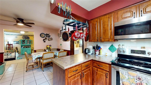 kitchen with backsplash, stainless steel appliances, ceiling fan, and light tile patterned flooring