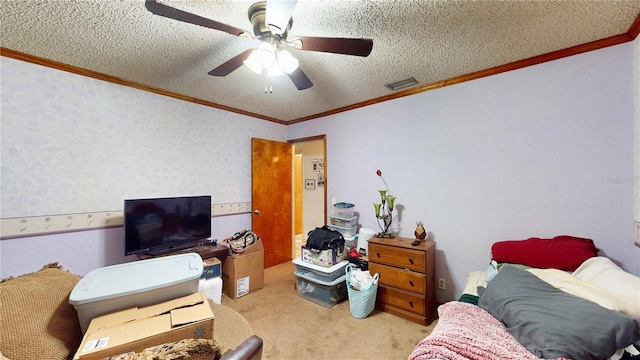 carpeted bedroom featuring ceiling fan, ornamental molding, and a textured ceiling