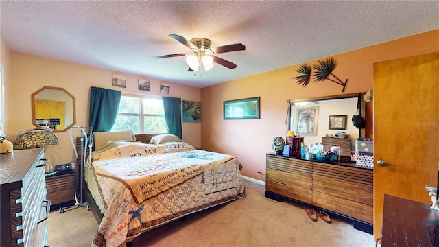 bedroom featuring ceiling fan, light carpet, and a textured ceiling