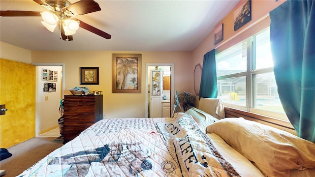 bedroom with carpet, ceiling fan, connected bathroom, and multiple windows