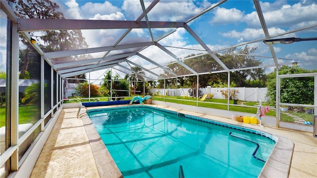 view of pool with glass enclosure