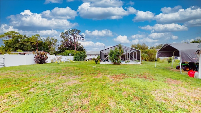 view of yard with a carport and a lanai