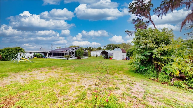 view of yard with a playground and a shed