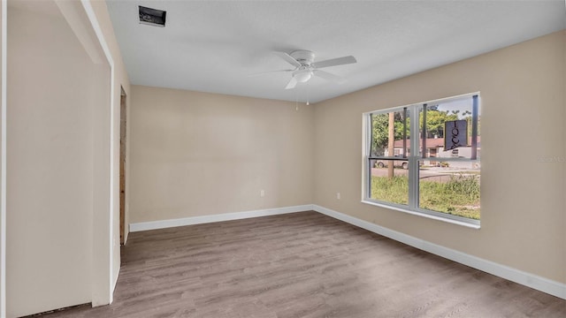 empty room featuring wood-type flooring and ceiling fan