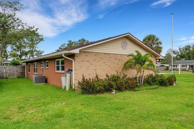 view of property exterior with a yard and cooling unit