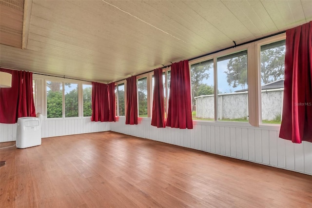 unfurnished sunroom with wood ceiling