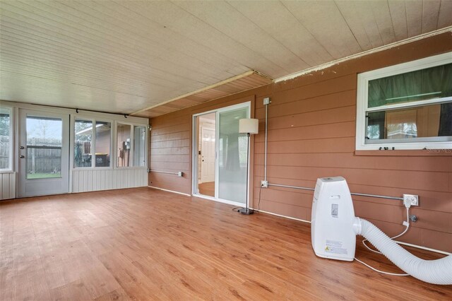 unfurnished sunroom with wood ceiling