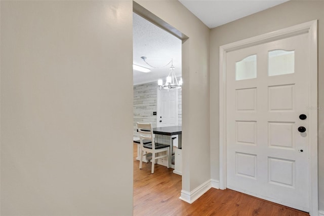 entryway featuring a notable chandelier and light wood-type flooring