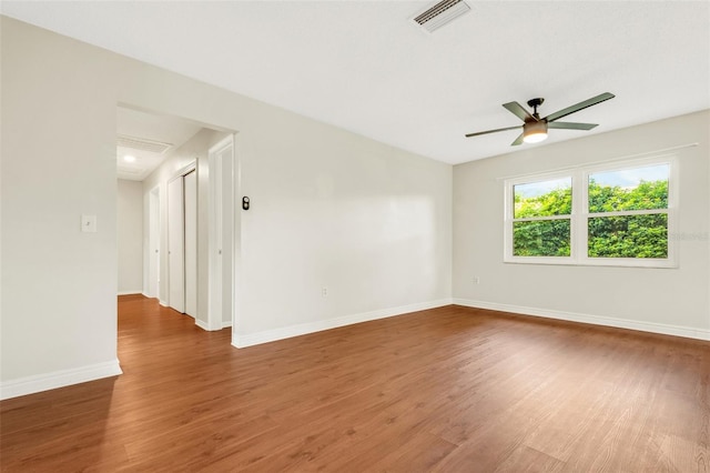 spare room featuring hardwood / wood-style floors and ceiling fan