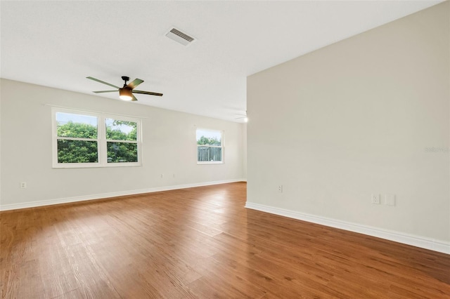 spare room with ceiling fan and light wood-type flooring