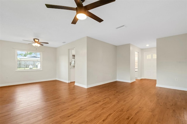 empty room with ceiling fan and light hardwood / wood-style floors