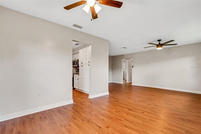 unfurnished living room with light hardwood / wood-style flooring and ceiling fan