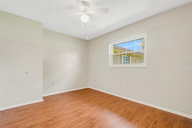 unfurnished room featuring a textured ceiling, hardwood / wood-style flooring, and ceiling fan