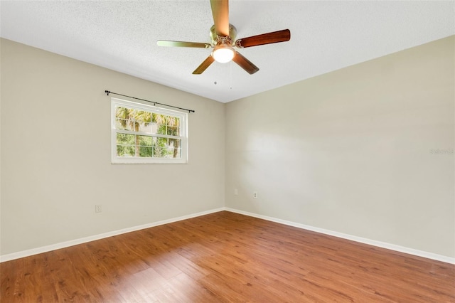 spare room featuring a textured ceiling, ceiling fan, and hardwood / wood-style floors