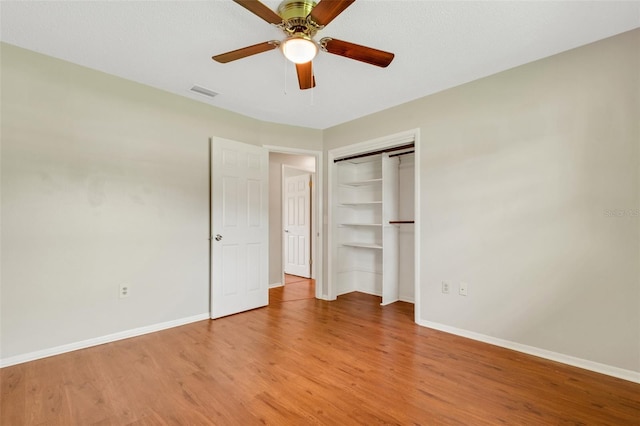 unfurnished bedroom featuring ceiling fan, a closet, and light hardwood / wood-style floors