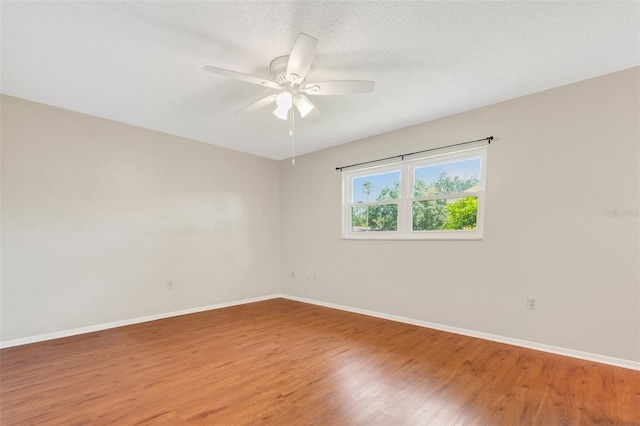 unfurnished room featuring ceiling fan, hardwood / wood-style flooring, and a textured ceiling