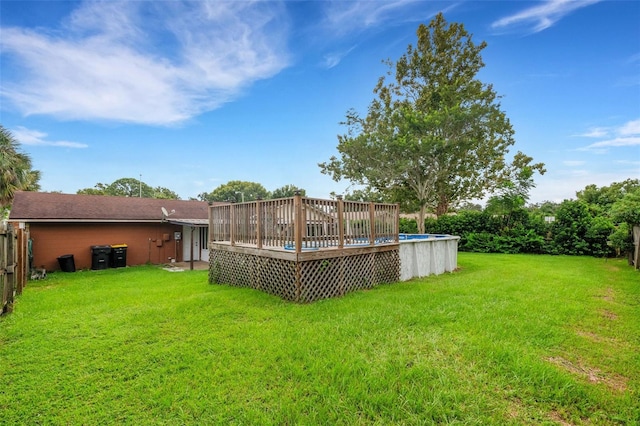 view of yard with a swimming pool side deck