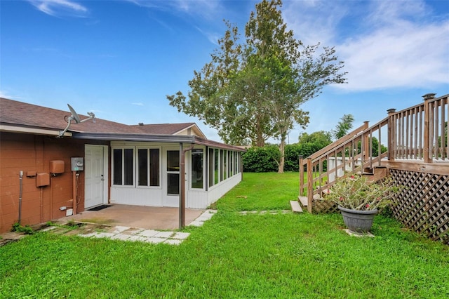 view of yard featuring a patio area and a sunroom