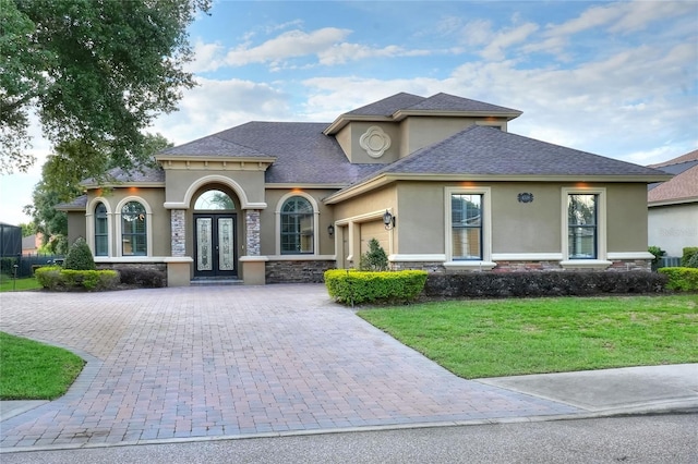 view of front of property featuring a garage and a front lawn