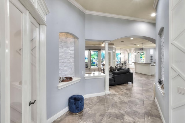 entryway featuring ceiling fan, light tile patterned flooring, and ornamental molding