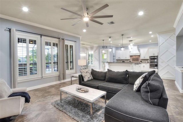 living room featuring crown molding, sink, ceiling fan, and light tile patterned floors