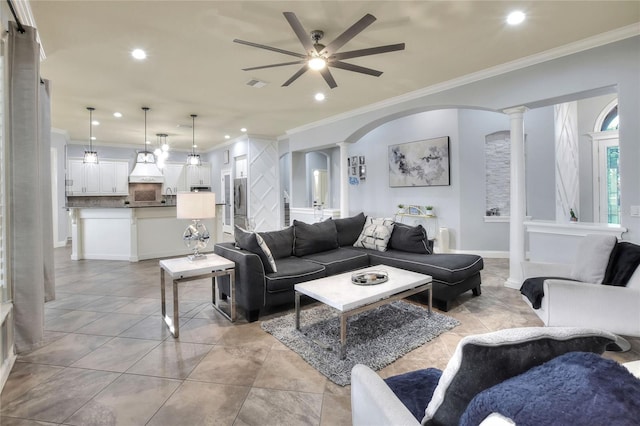 living room featuring ornate columns, ceiling fan, and crown molding