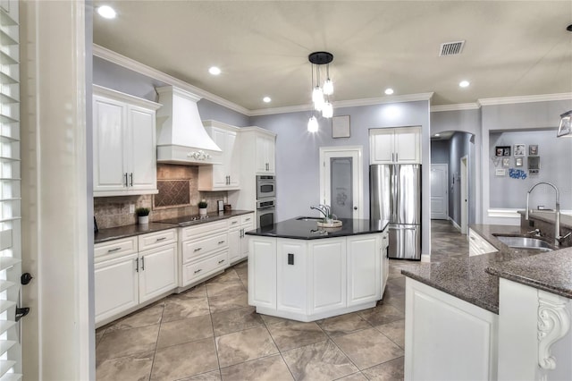 kitchen with premium range hood, stainless steel fridge, sink, and white cabinets