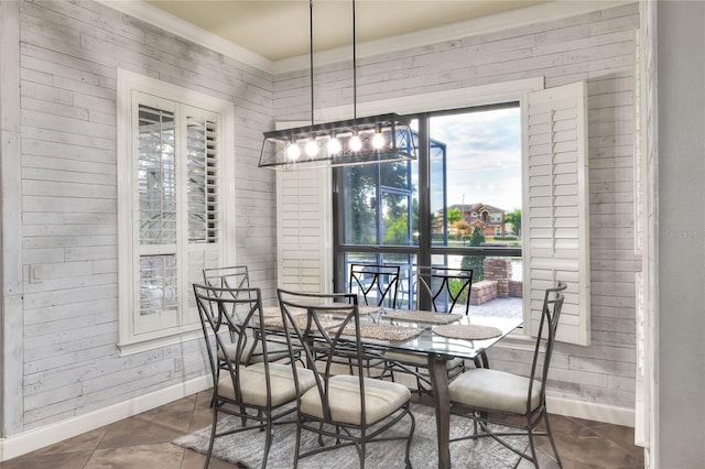 dining area featuring wood walls