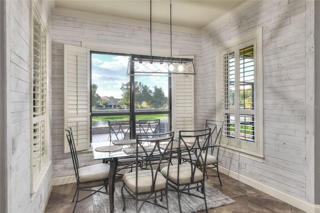 dining room with wood walls