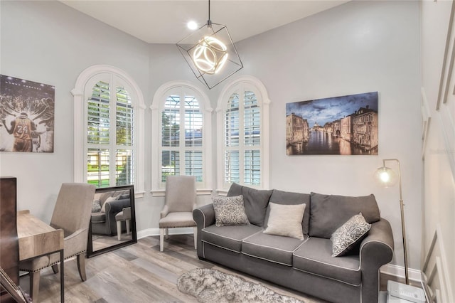 living room with a chandelier and light hardwood / wood-style floors