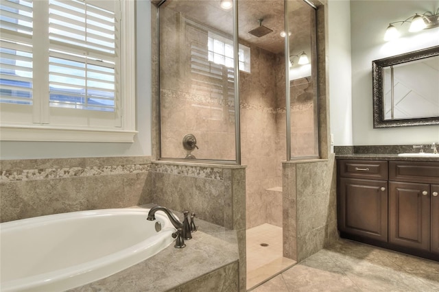 bathroom with vanity and separate shower and tub