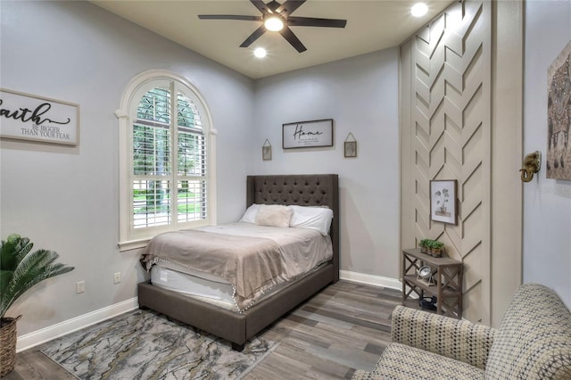 bedroom with hardwood / wood-style floors and ceiling fan