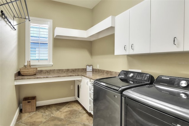 washroom with washer and clothes dryer and cabinets